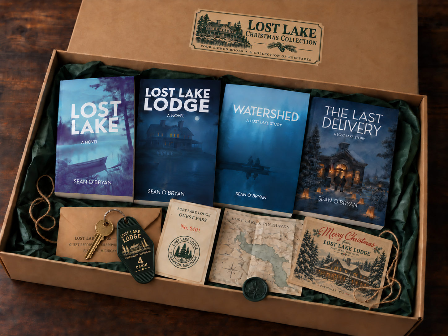 The Lost Lake Christmas Collection: four books in a kraft gift box, with a green Lodge keyring and brass key, guest pass, map, envelope, and Christmas postcard.